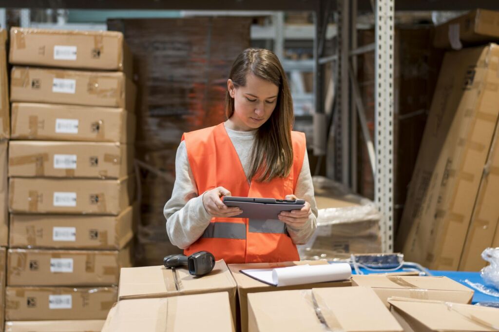 a woman in a warehouse using a tablet